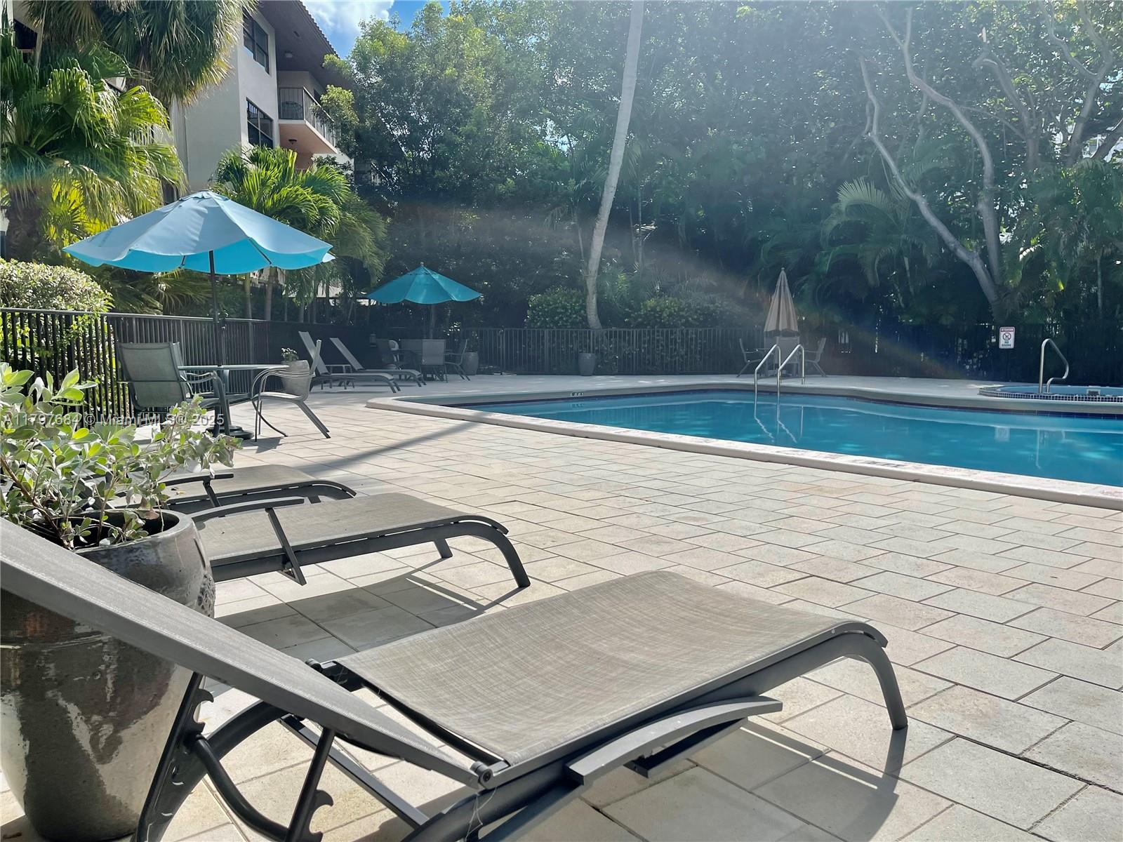 55 Ocean Ln Drive, Unit 2030 Key Biscayne, FL 33149 - Photo 18 of 19 a view of a backyard with sitting area