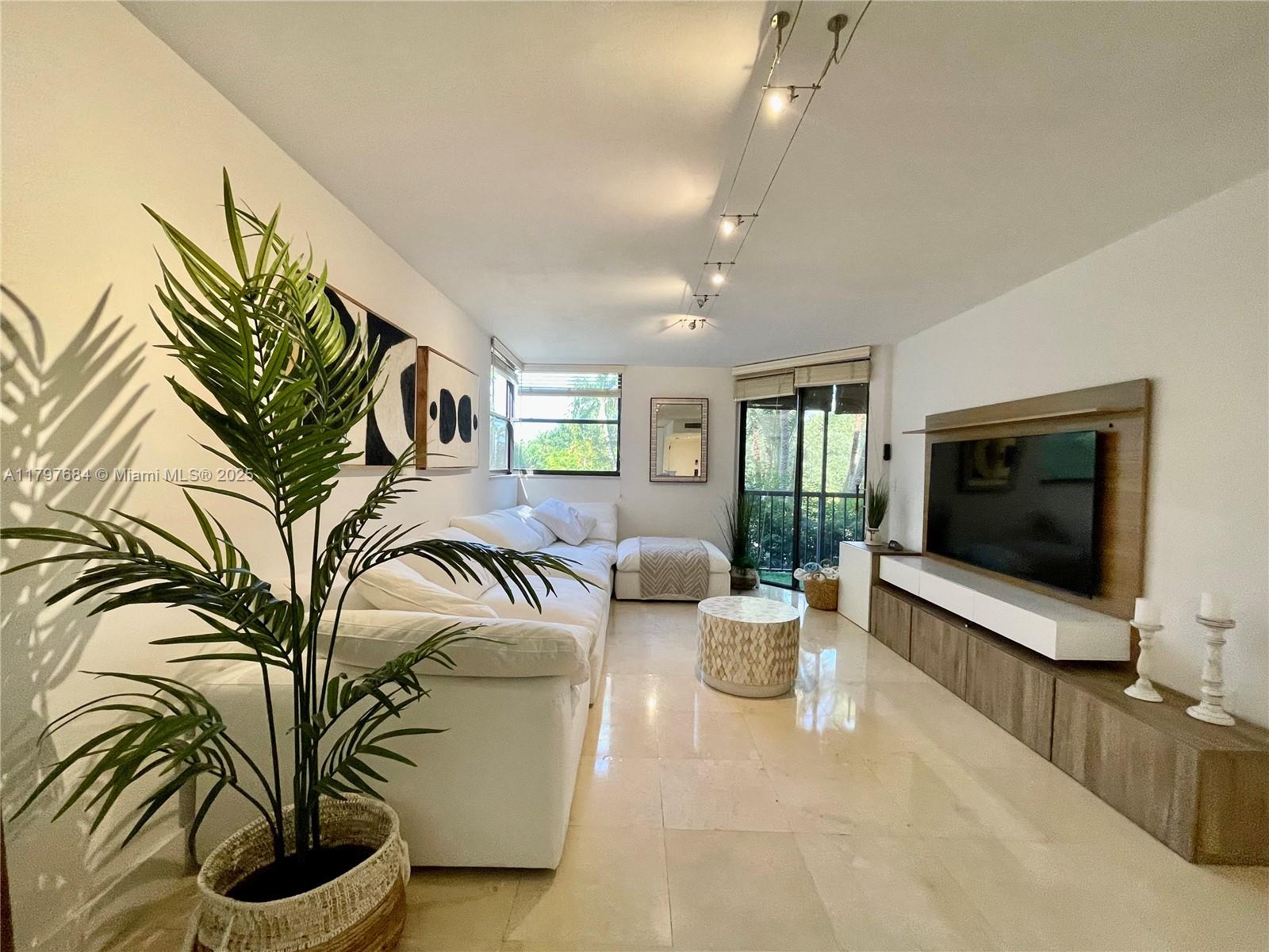 55 Ocean Ln Drive, Unit 2030 Key Biscayne, FL 33149 - Photo 2 of 19 a living room with furniture and a flat screen tv