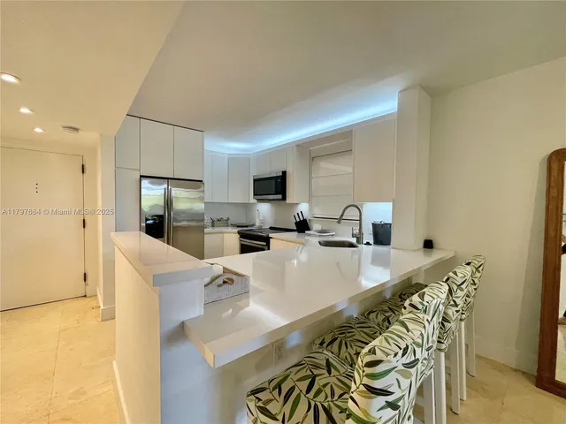 a large kitchen with a table and chairs