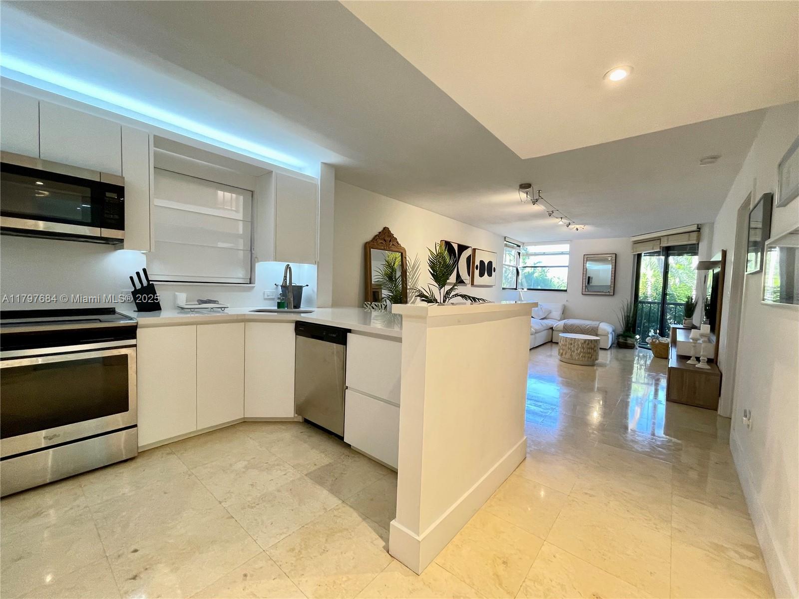 55 Ocean Ln Drive, Unit 2030 Key Biscayne, FL 33149 - Photo 8 of 19 a kitchen with a sink stove and cabinets