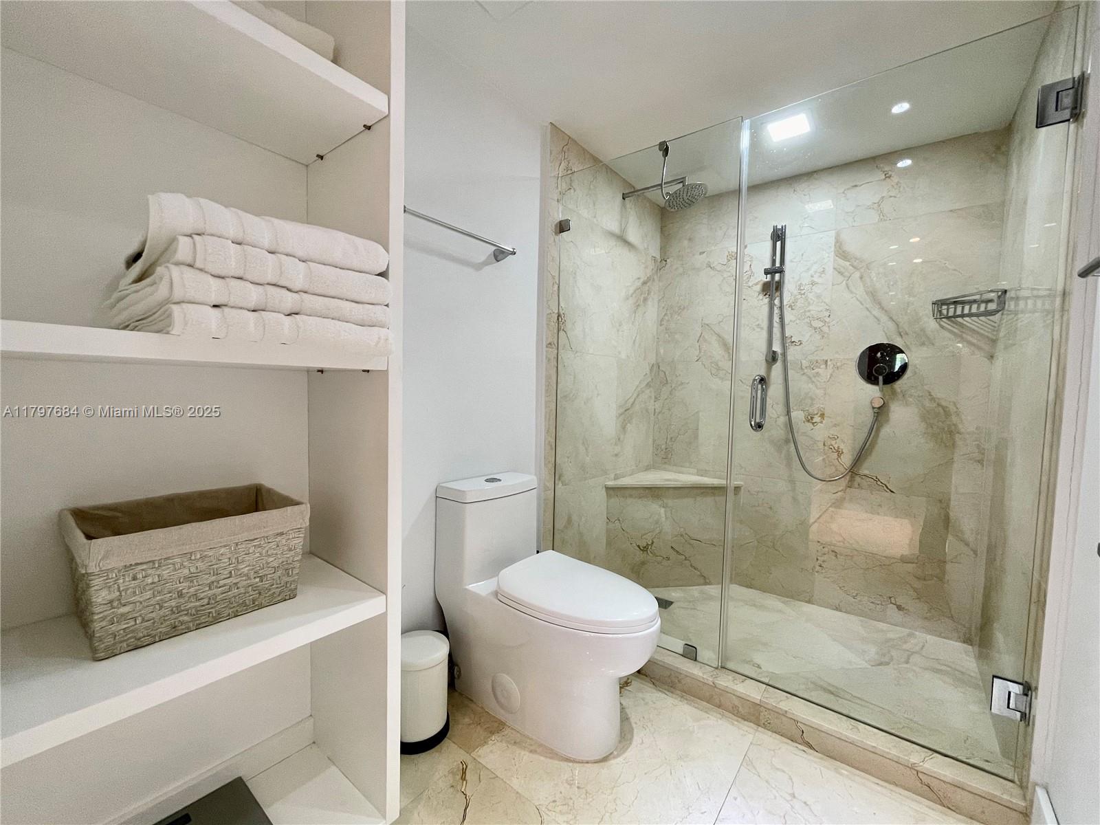 55 Ocean Ln Drive, Unit 2030 Key Biscayne, FL 33149 - Photo 9 of 19 a bathroom with a granite countertop shower a toilet and a sink