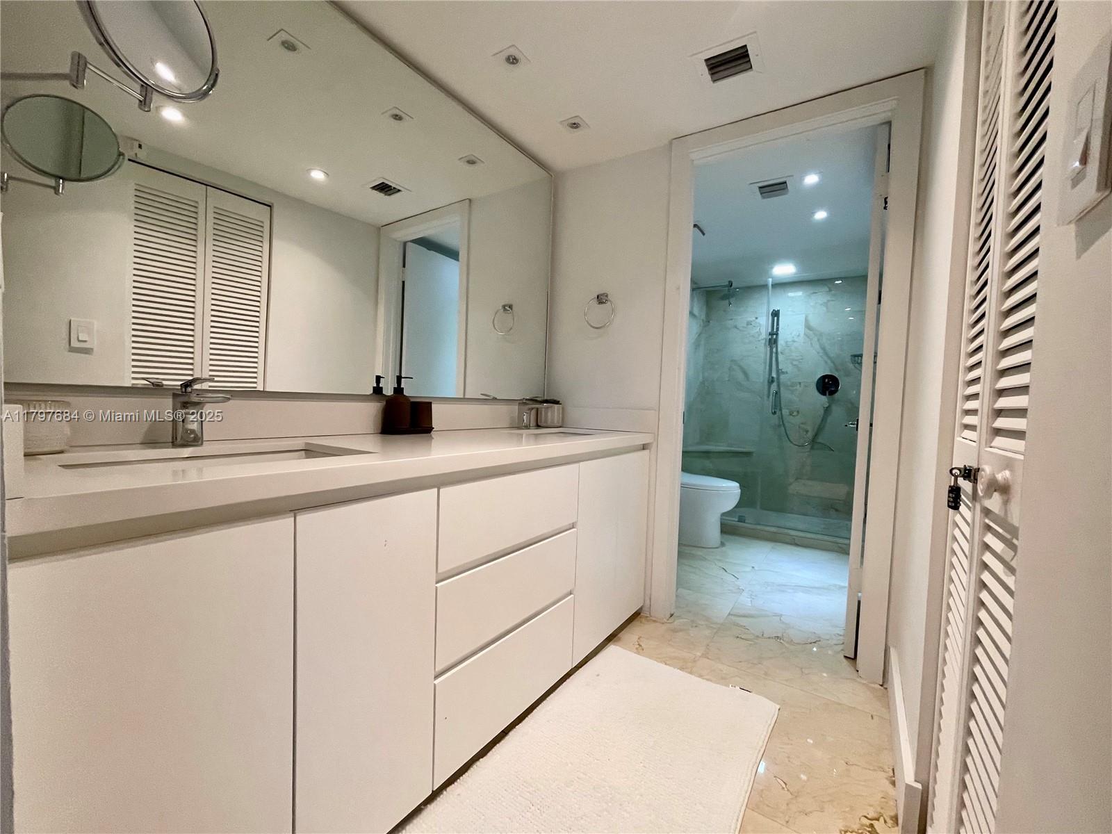 55 Ocean Ln Drive, Unit 2030 Key Biscayne, FL 33149 - Photo 10 of 19 a bathroom with a double vanity sink mirror and shower