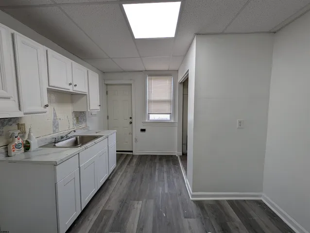 a kitchen with a sink a stove and cabinets