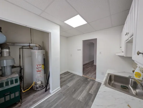 a view of a kitchen with wooden floor and a sink