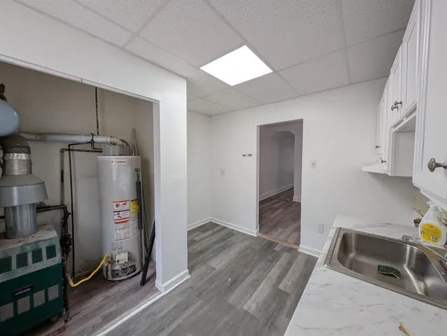 a view of a kitchen with wooden floor and a sink