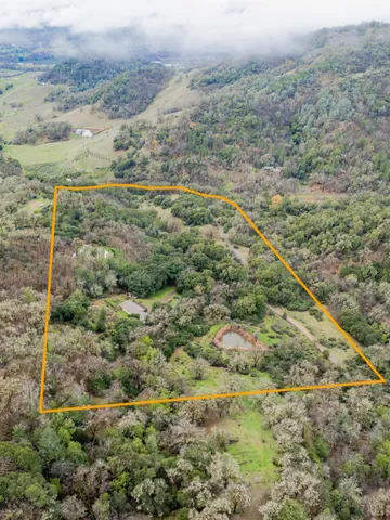 a view of a field with an ocean view