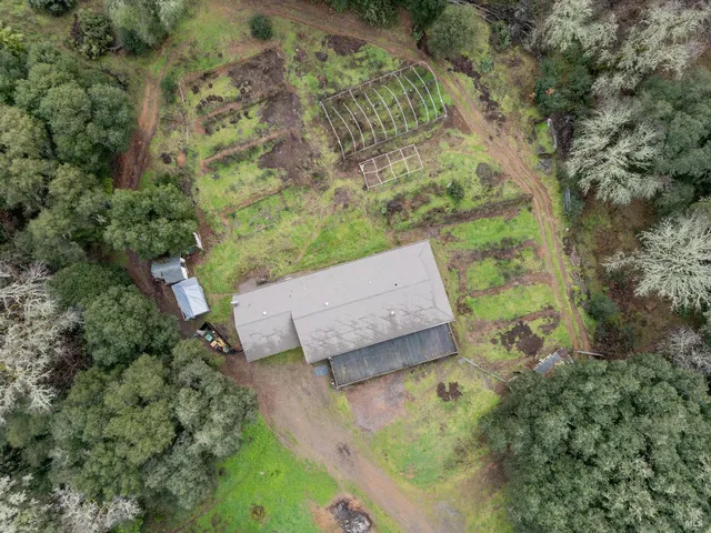 an aerial view of a house with a yard