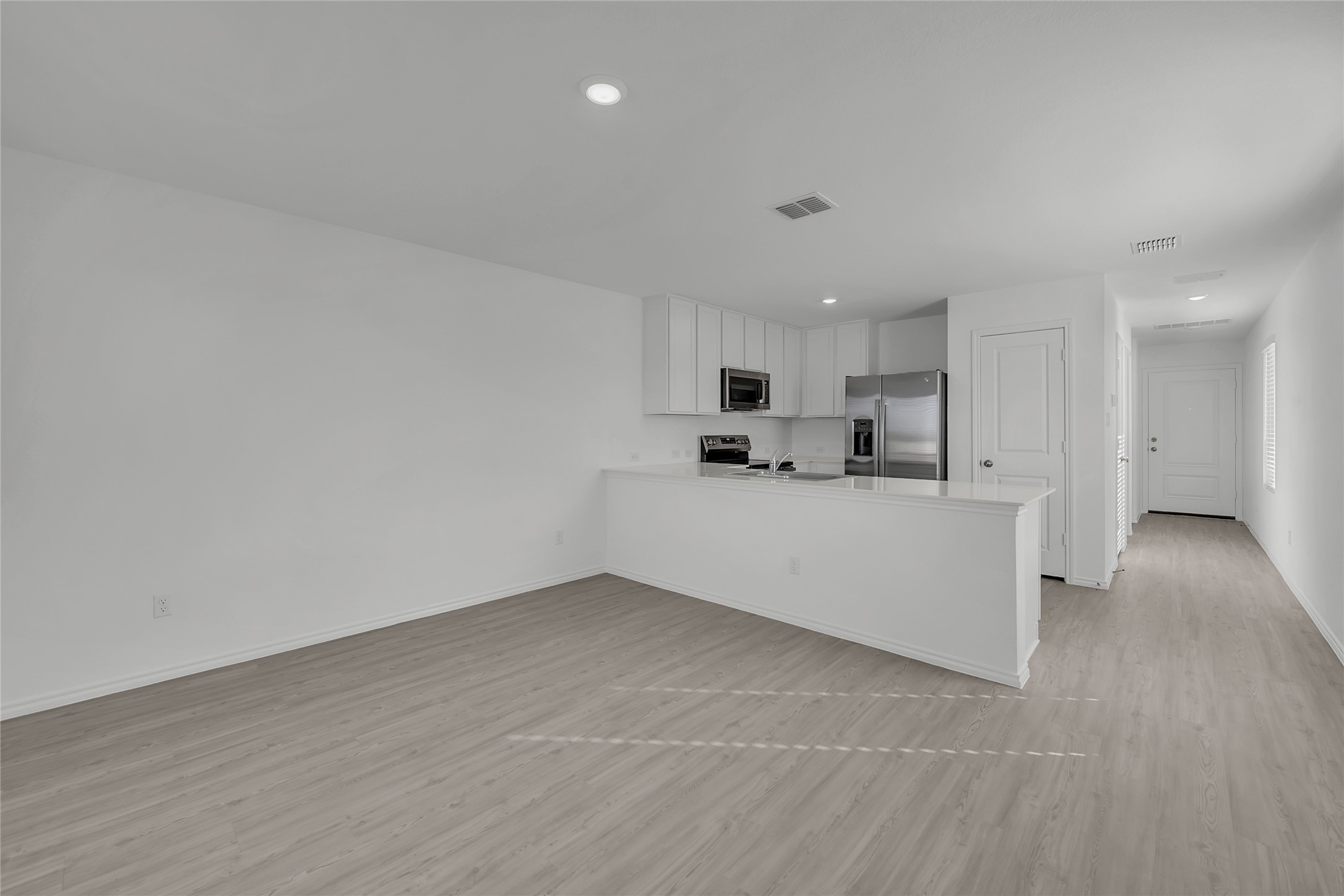 309 Marty Allen Loop Jarrell, TX 76537 - Photo 5 of 33 Spacious open-concept living area with wood-finish flooring