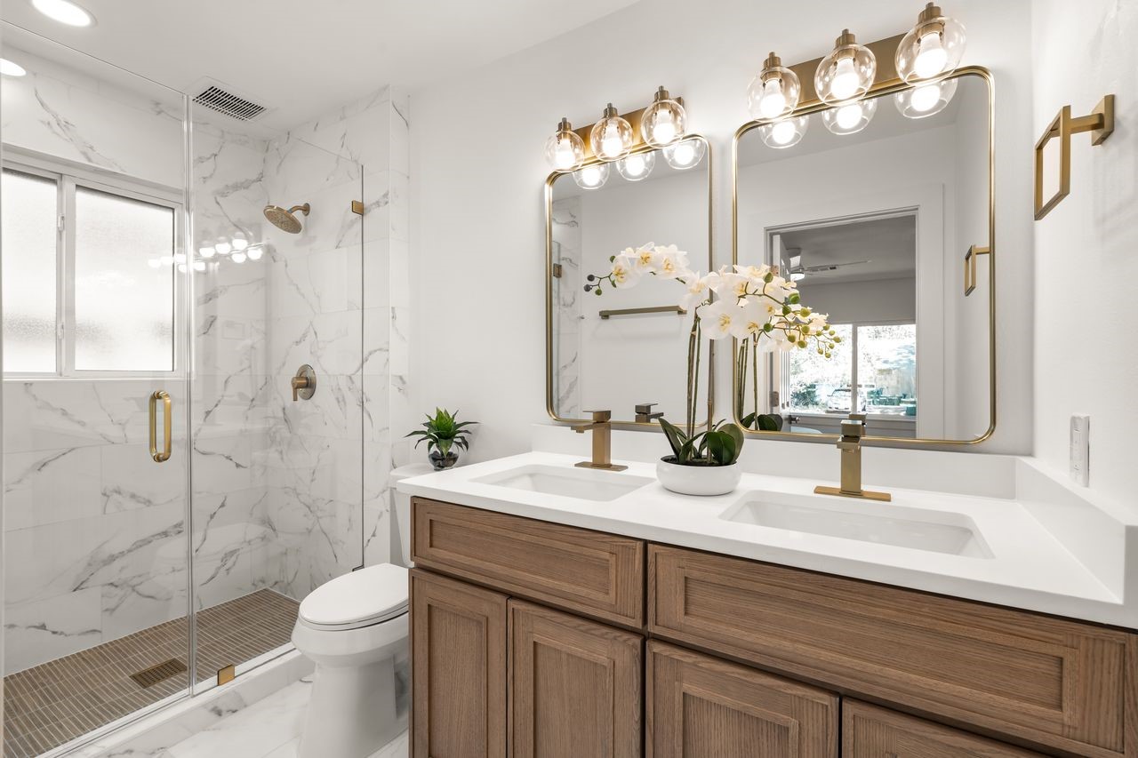 5207 Hummingbird Street Houston, TX 77035 - Photo 16 of 23 Updated primary bath with double vanity, glass-enclosed walk-in shower, marble-look tile and modern finished