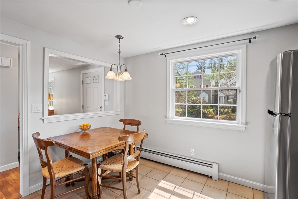 66 Old Stow Road Concord, MA 01742 - Photo 13 of 42 a view of a dining room with furniture window and wooden floor