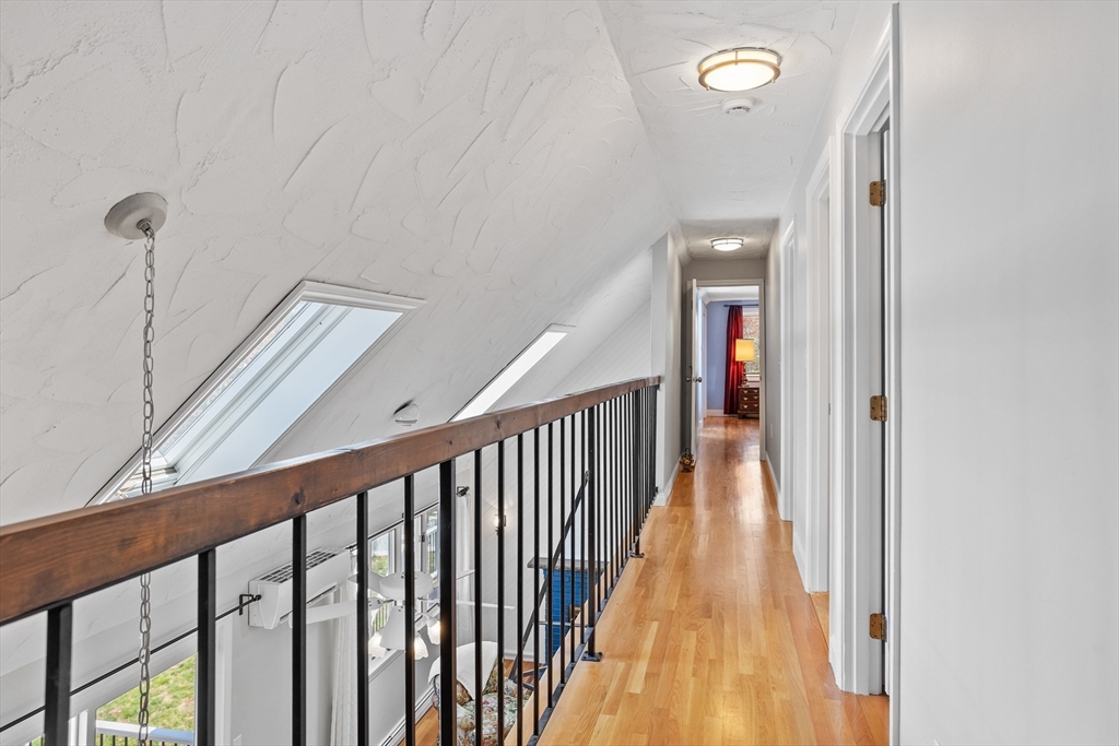 66 Old Stow Road Concord, MA 01742 - Photo 22 of 42 a view of a hallway with wooden floor and stairs