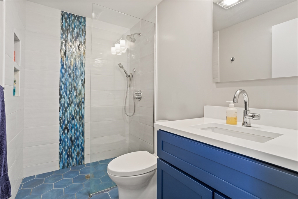 66 Old Stow Road Concord, MA 01742 - Photo 25 of 42 a bathroom with a sink a toilet and shower