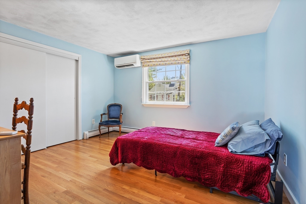 66 Old Stow Road Concord, MA 01742 - Photo 26 of 42 a bedroom with a bed and wooden floor