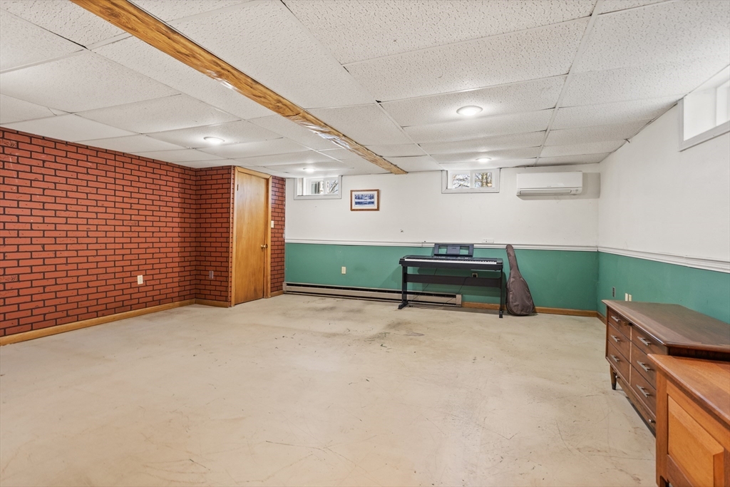 66 Old Stow Road Concord, MA 01742 - Photo 34 of 42 a room with a furniture and air conditioner vent