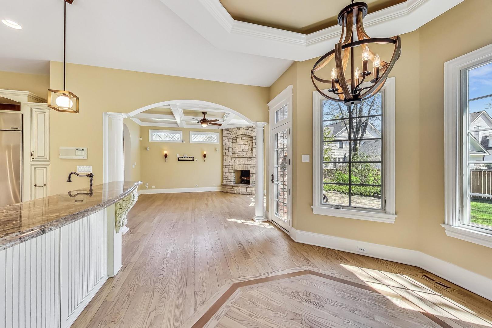 136 Fuller Road Hinsdale, IL 60521 - Photo 12 of 53 a view of a bedroom with wooden floor and windows