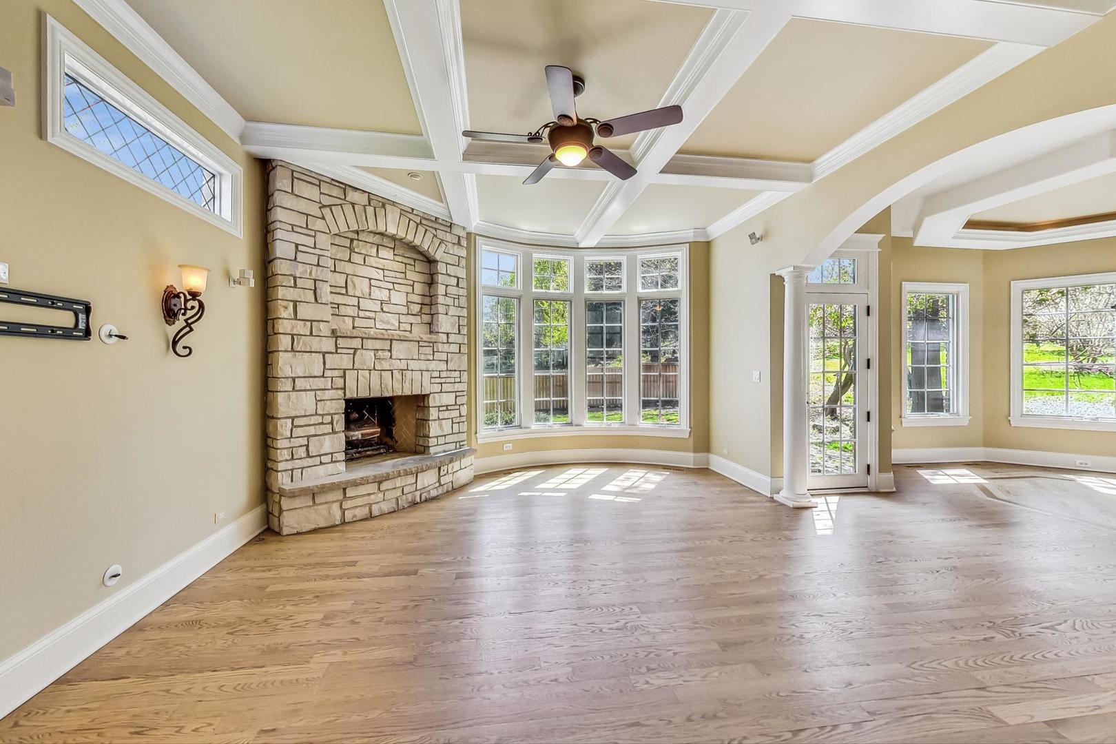 136 Fuller Road Hinsdale, IL 60521 - Photo 14 of 53 a view of an empty room with wooden floor fireplace and a window