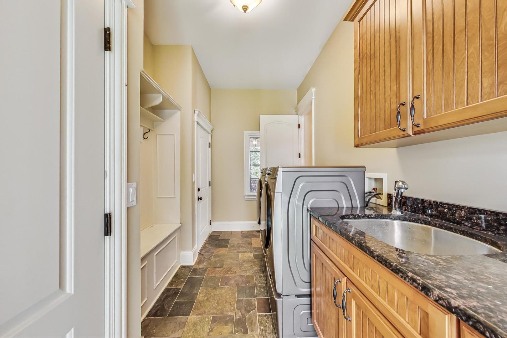 136 Fuller Road Hinsdale, IL 60521 - Photo 17 of 53 a kitchen with granite countertop a sink and a refrigerator