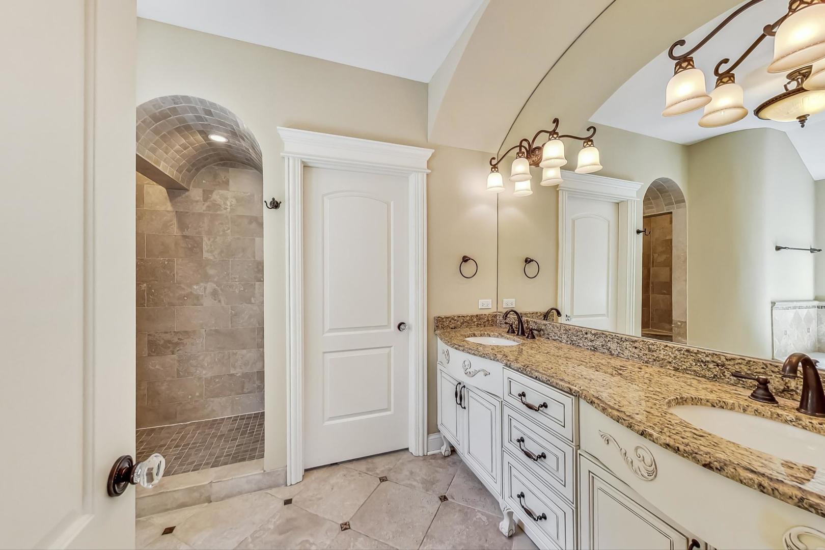136 Fuller Road Hinsdale, IL 60521 - Photo 20 of 53 a spacious bathroom with a granite countertop sink a mirror and a shower