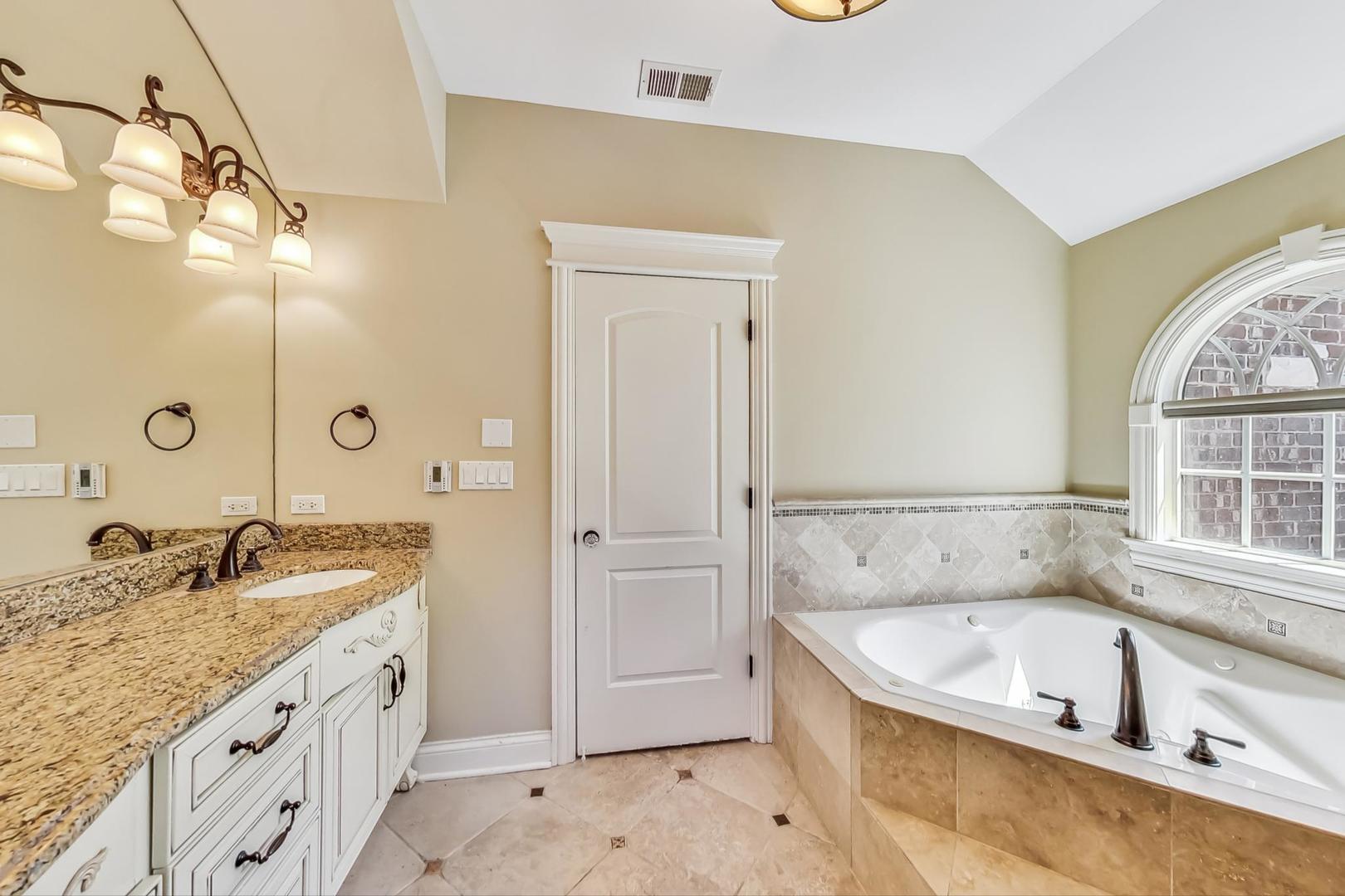136 Fuller Road Hinsdale, IL 60521 - Photo 22 of 53 a bathroom with a granite countertop tub sink and mirror