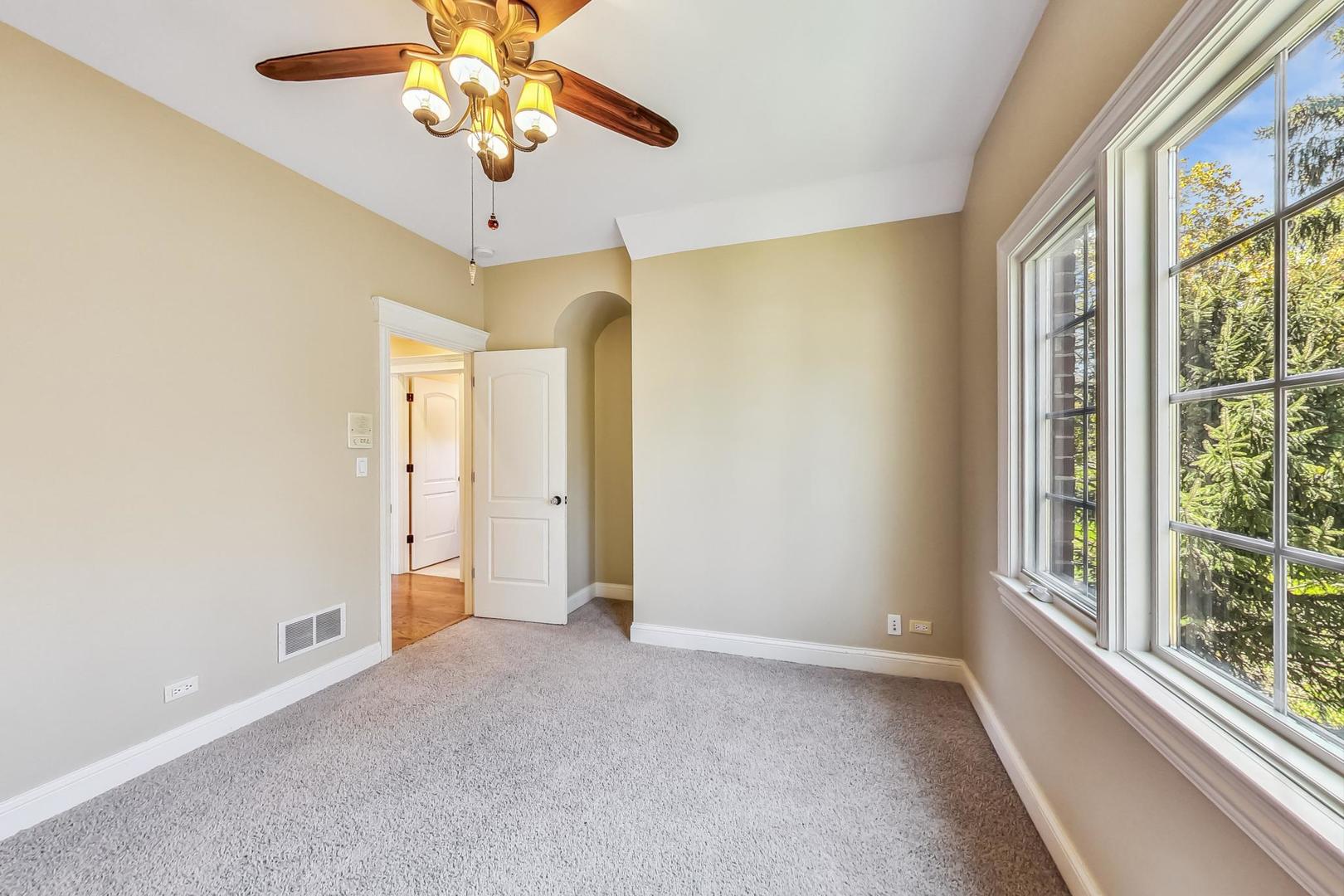 136 Fuller Road Hinsdale, IL 60521 - Photo 33 of 53 a view of a livingroom with a chandelier fan and windows