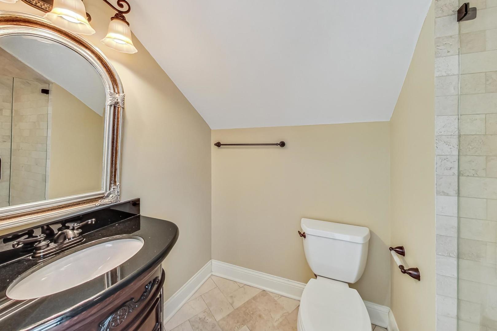 136 Fuller Road Hinsdale, IL 60521 - Photo 35 of 53 a bathroom with a toilet a sink and mirror