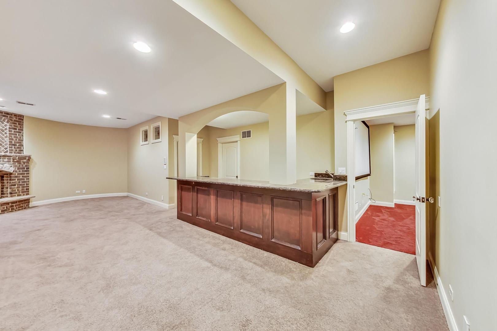 136 Fuller Road Hinsdale, IL 60521 - Photo 38 of 53 a view of a hallway with cabinet a mirror and a cabinet