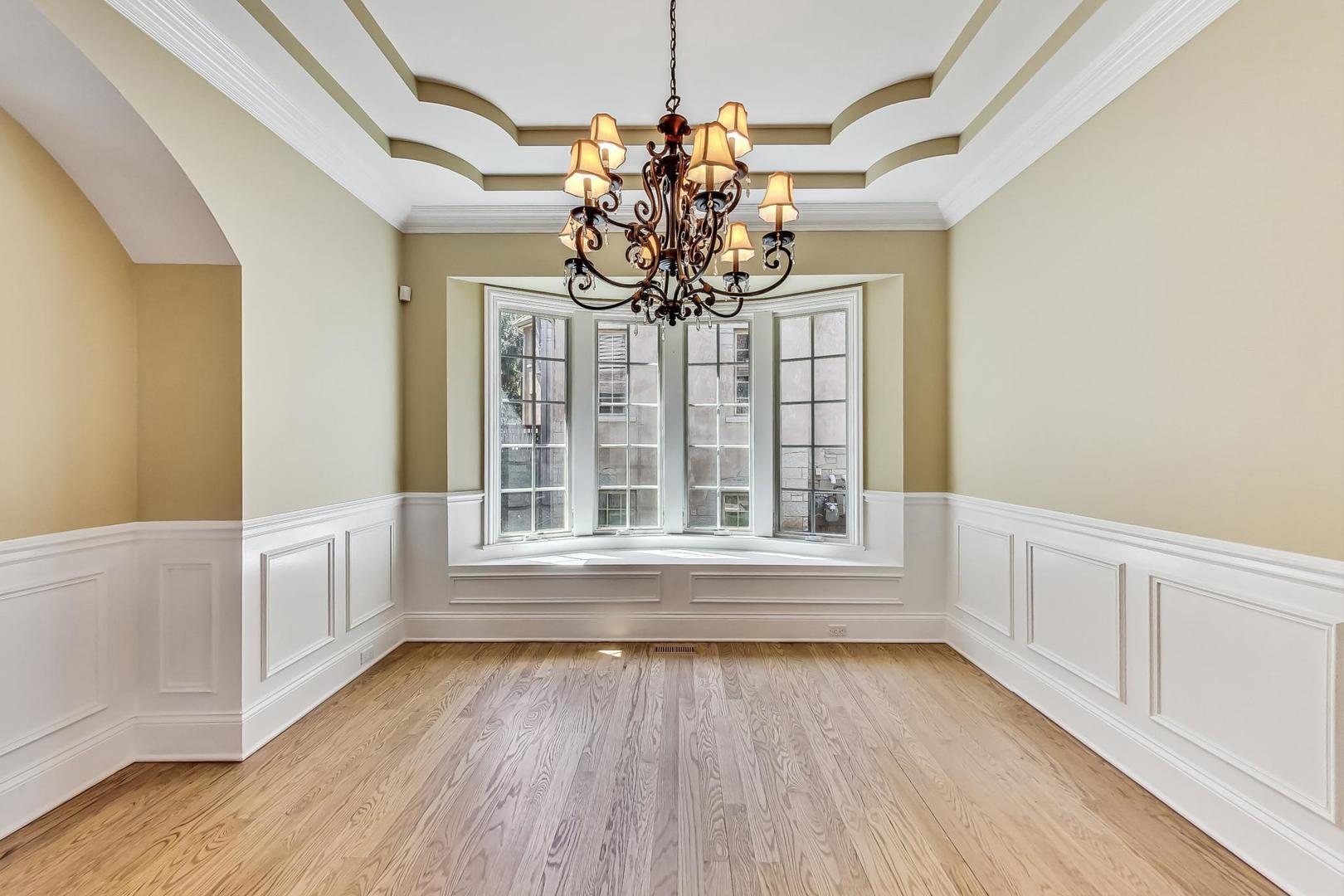 136 Fuller Road Hinsdale, IL 60521 - Photo 6 of 53 a view of an empty room with wooden floor and a window