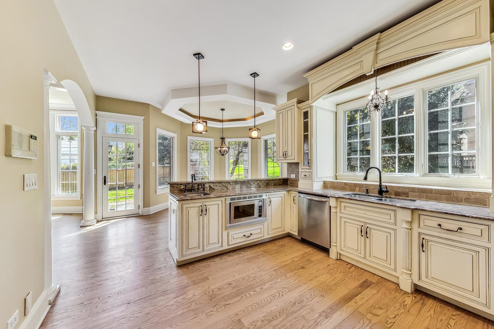 136 Fuller Road Hinsdale, IL 60521 - Photo 8 of 53 a large kitchen with stainless steel appliances granite countertop a stove and a wooden floors