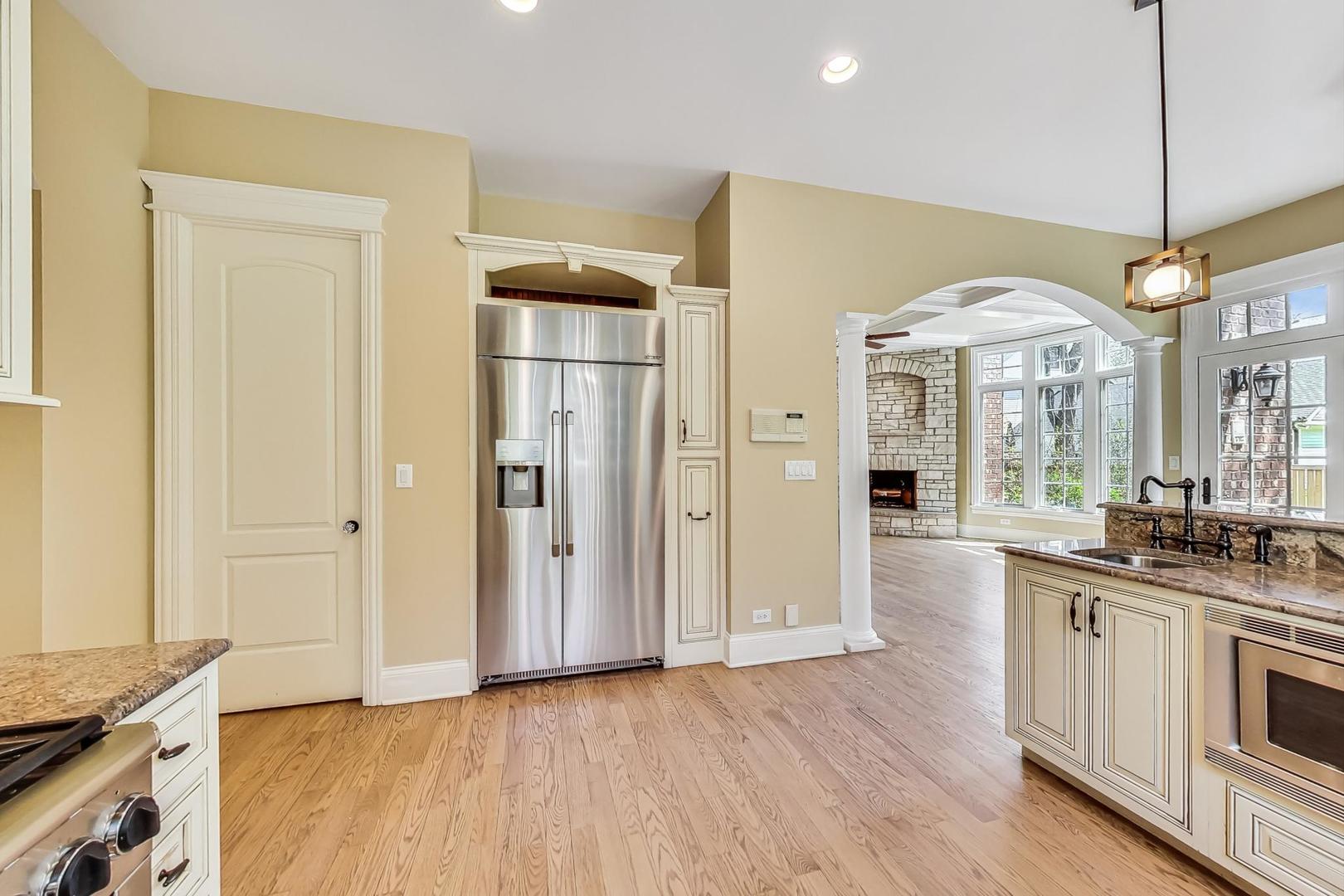 136 Fuller Road Hinsdale, IL 60521 - Photo 10 of 53 a open kitchen with stainless steel appliances granite countertop a stove a sink and a refrigerator with wooden floor