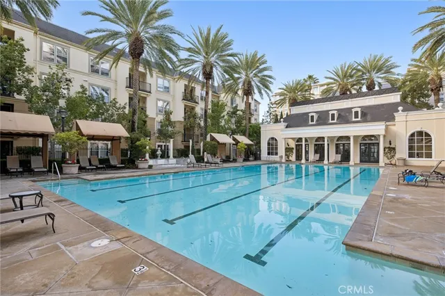 a view of a house with swimming pool and sitting area