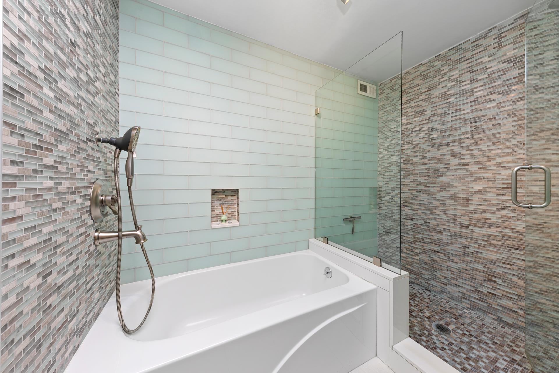 137 East 36th Street, Unit 5B Manhattan, NY 10016 - Photo 9 of 30 a bathroom with a white bath tub and shower