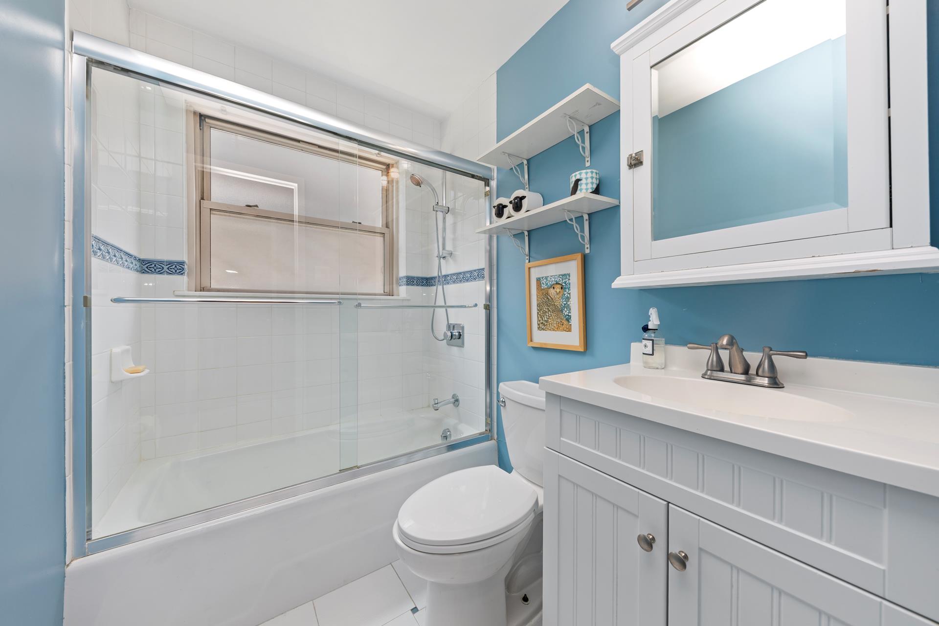 137 East 36th Street, Unit 5B Manhattan, NY 10016 - Photo 12 of 30 a bathroom with a sink a toilet and a mirror