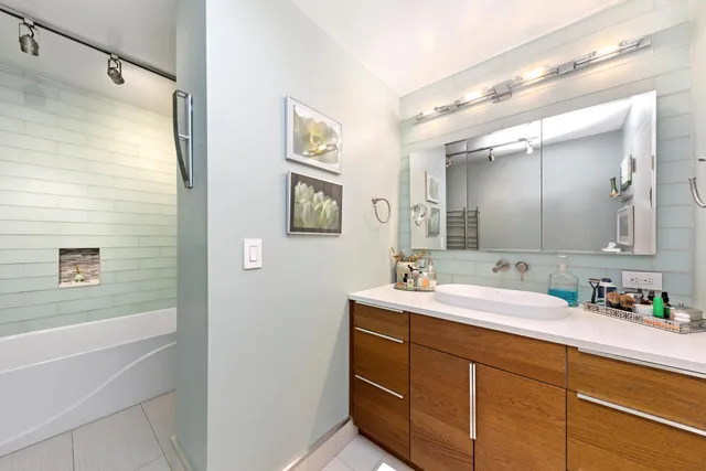 a bathroom with a double vanity sink mirror and shower