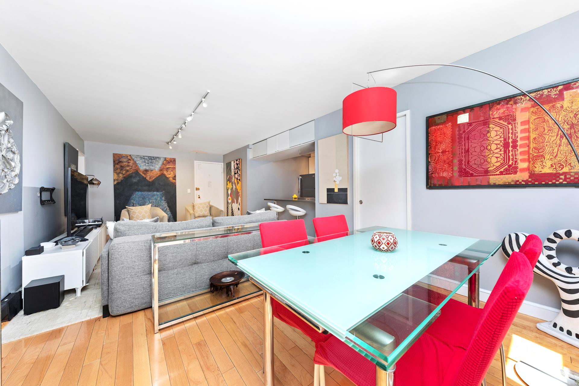 137 East 36th Street, Unit 5B Manhattan, NY 10016 - Photo 20 of 30 a living room with a floor to ceiling window and kitchen view