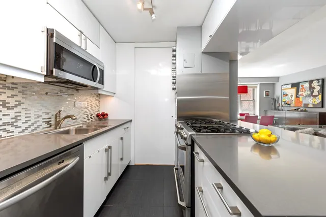a kitchen with stainless steel appliances a stove a microwave and cabinets