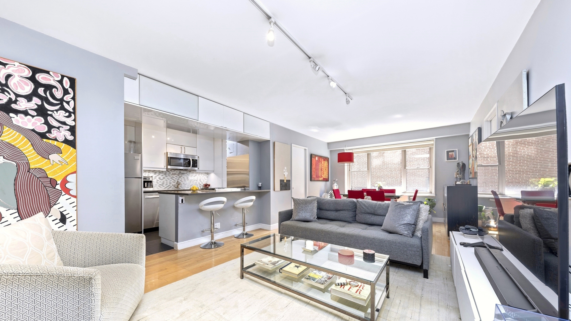 137 East 36th Street, Unit 5B Manhattan, NY 10016 - Photo 2 of 30 a living room with furniture and a flat screen tv