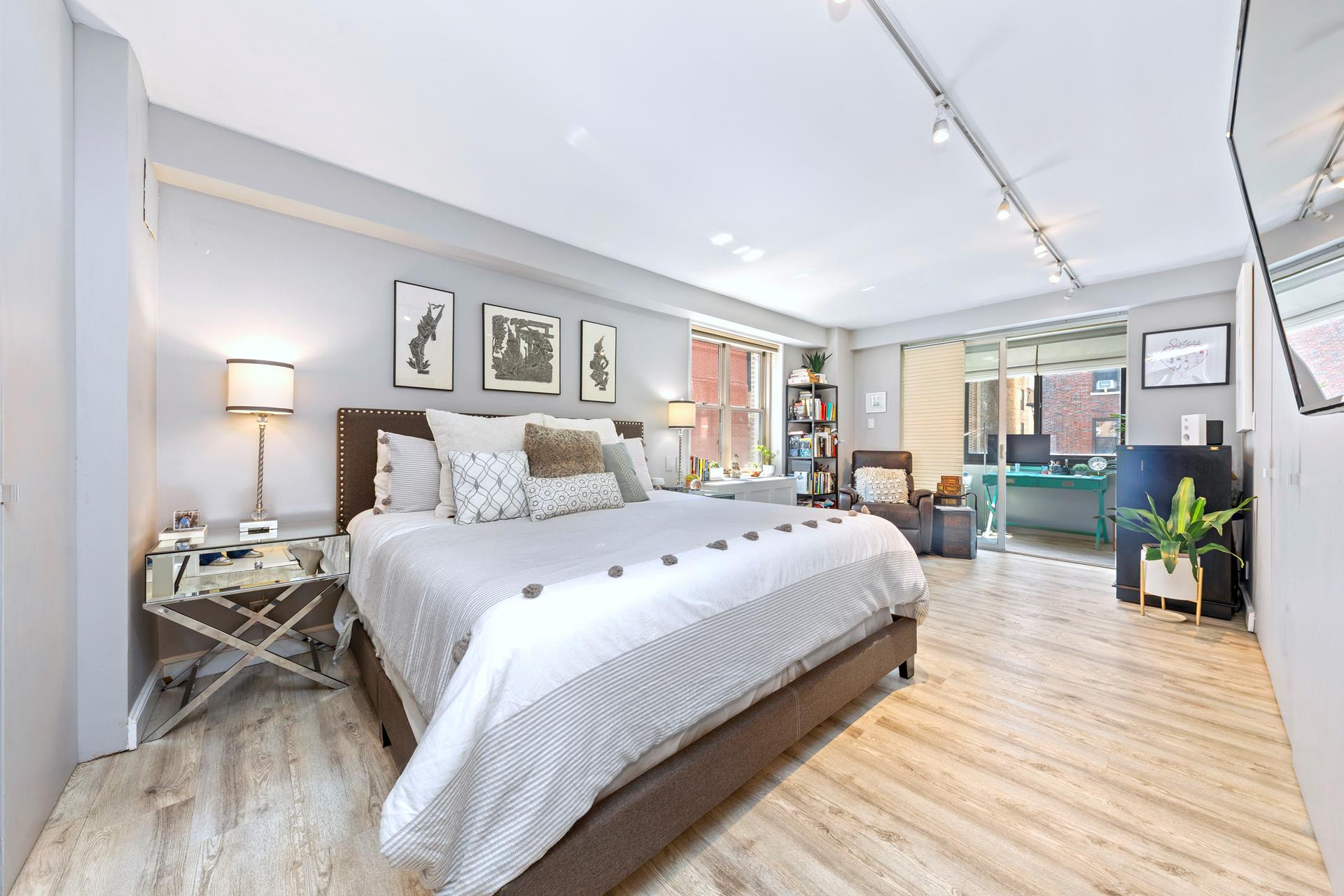 137 East 36th Street, Unit 5B Manhattan, NY 10016 - Photo 5 of 30 a bedroom with a bed and wooden floor