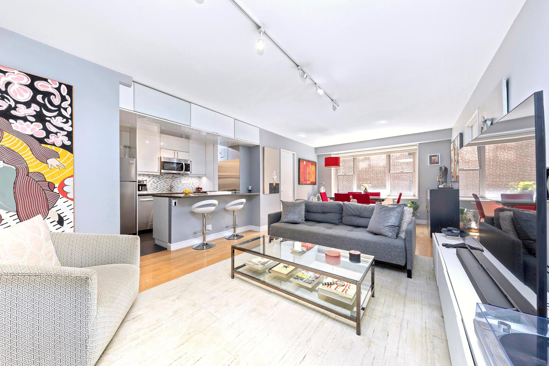 137 East 36th Street, Unit 5B Manhattan, NY 10016 - Photo 6 of 30 a living room with furniture and a flat screen tv