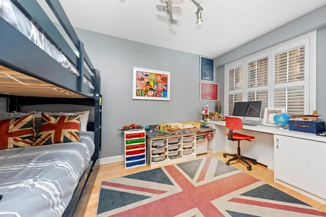 a bedroom with furniture and a book shelf