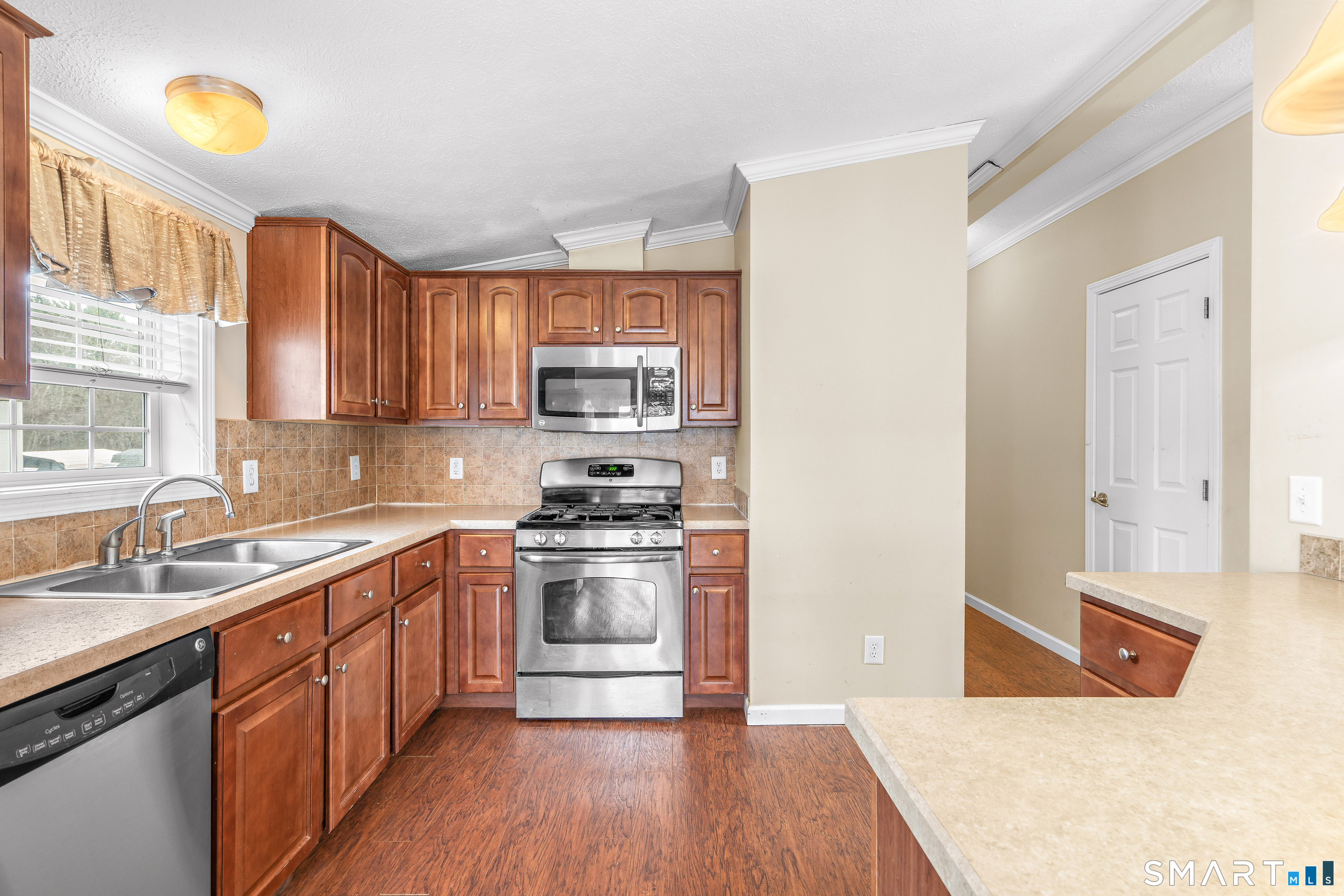 301 South Main Street Newtown, CT 06470 - Photo 11 of 23 a kitchen with stainless steel appliances granite countertop a sink stove and refrigerator
