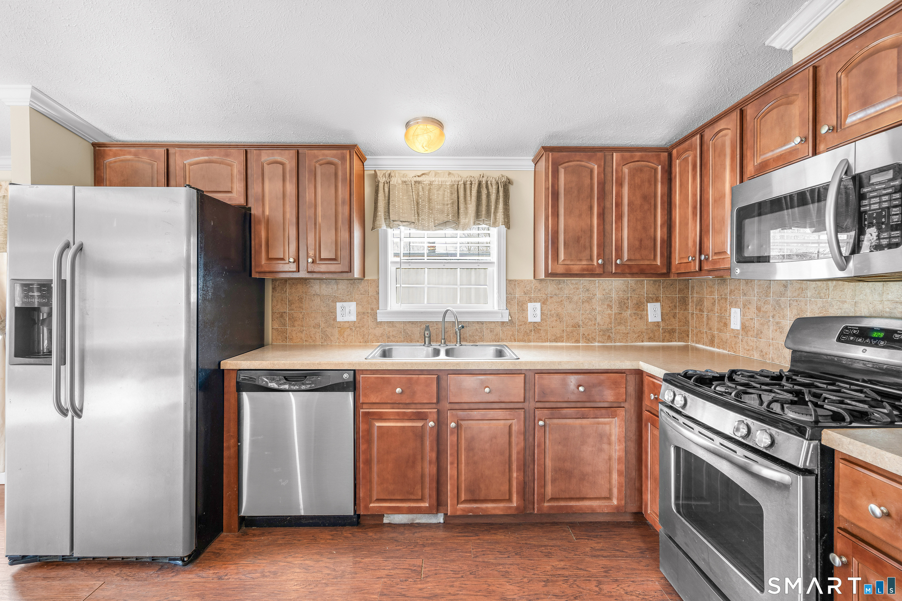 301 South Main Street Newtown, CT 06470 - Photo 12 of 23 a kitchen with stainless steel appliances granite countertop a stove a sink dishwasher and a refrigerator