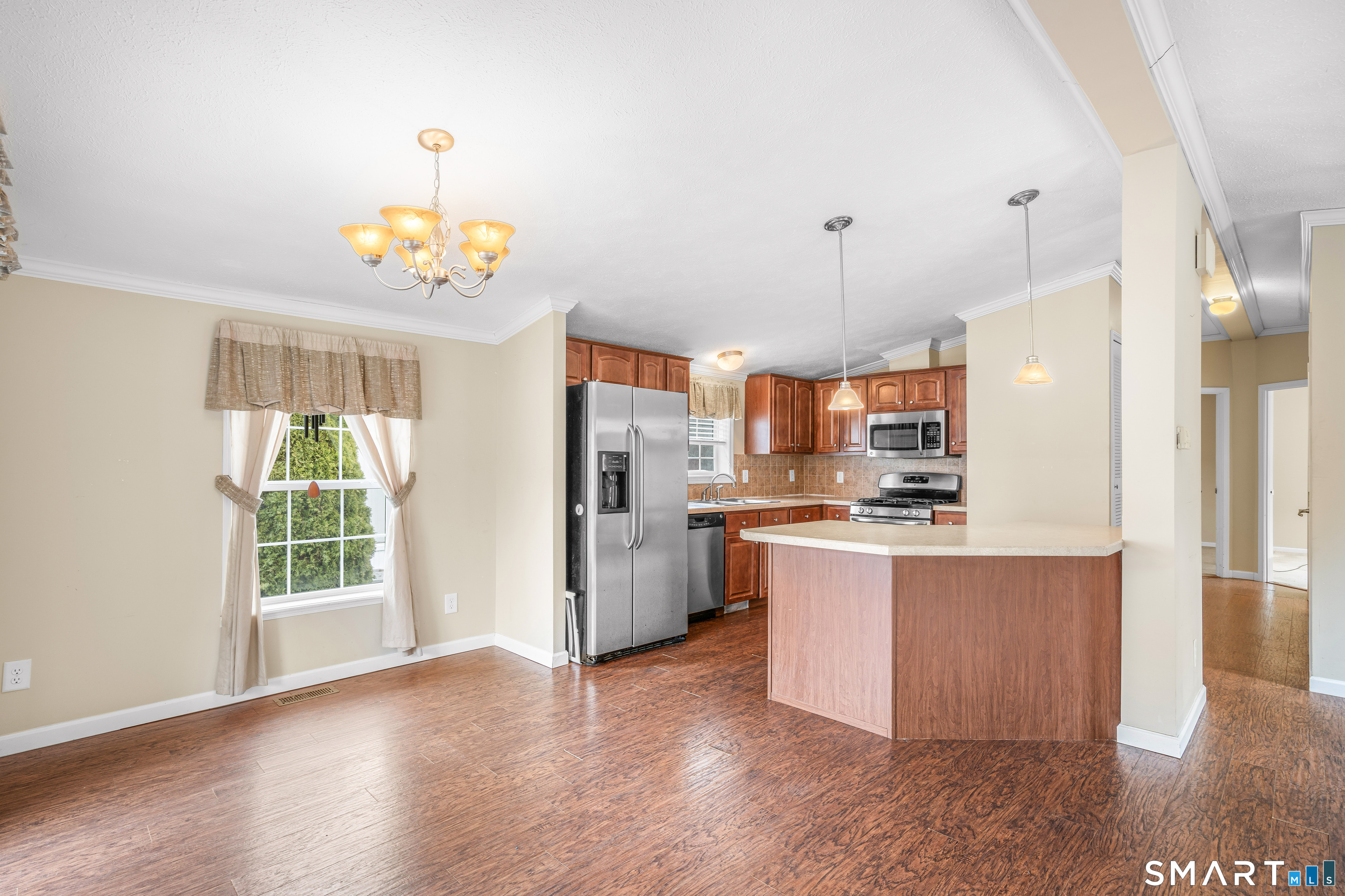 301 South Main Street Newtown, CT 06470 - Photo 9 of 23 a kitchen with refrigerator and wooden floor
