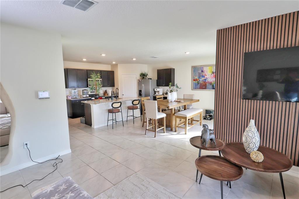 1724 Buckeye Road Davenport, FL 33837 - Photo 12 of 53 a living room with lots of furniture and a painting on the wall