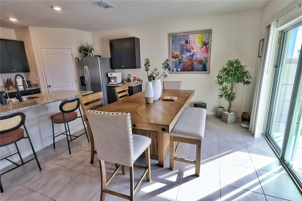 1724 Buckeye Road Davenport, FL 33837 - Photo 13 of 53 a view of a livingroom with furniture and a flat screen tv