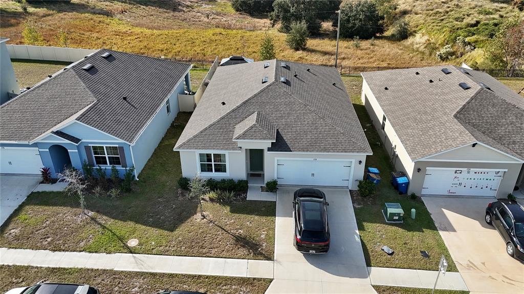1724 Buckeye Road Davenport, FL 33837 - Photo 2 of 53 an aerial view of residential houses with outdoor space