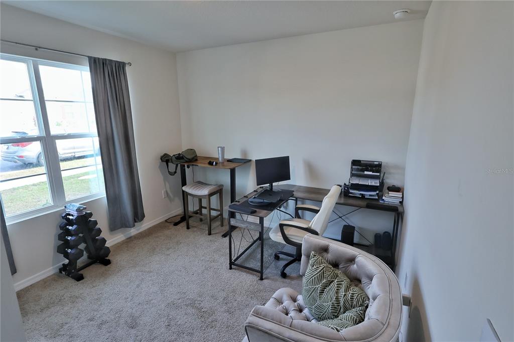 1724 Buckeye Road Davenport, FL 33837 - Photo 35 of 53 a living room with furniture and a window