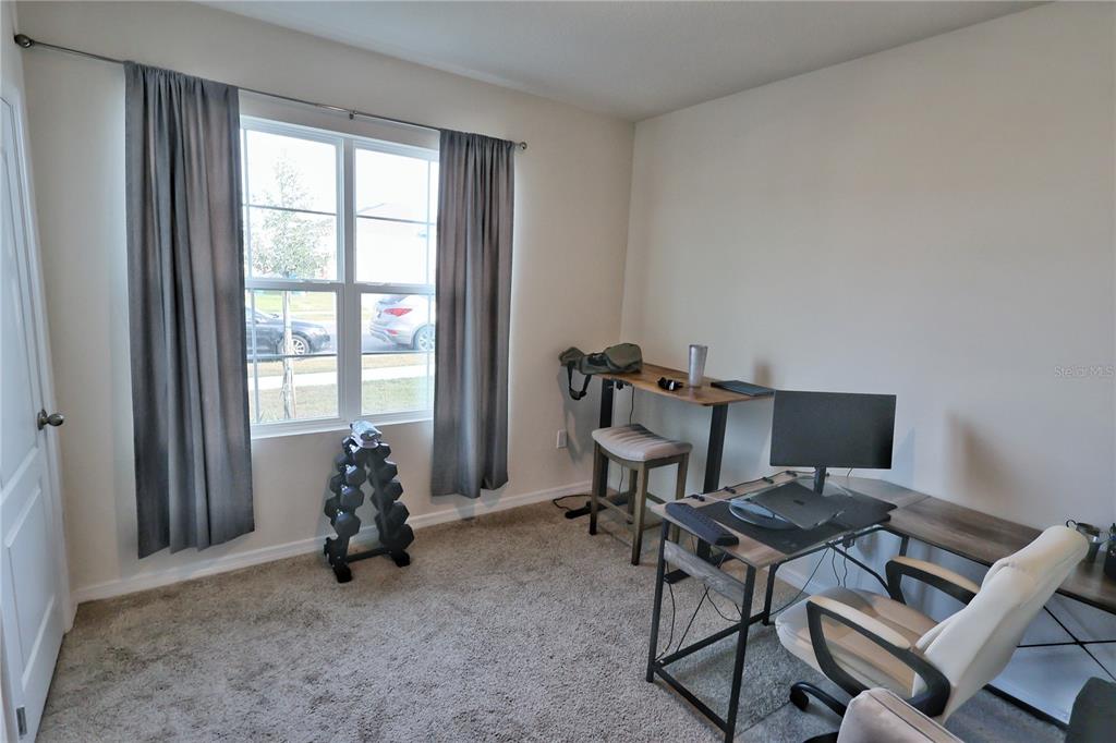 1724 Buckeye Road Davenport, FL 33837 - Photo 36 of 53 a view of a workspace with furniture and a window