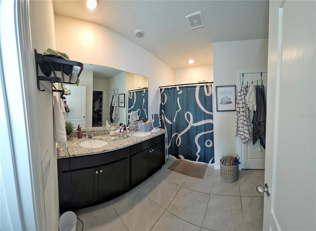 1724 Buckeye Road Davenport, FL 33837 - Photo 43 of 53 a bathroom with a sink mirror and shower