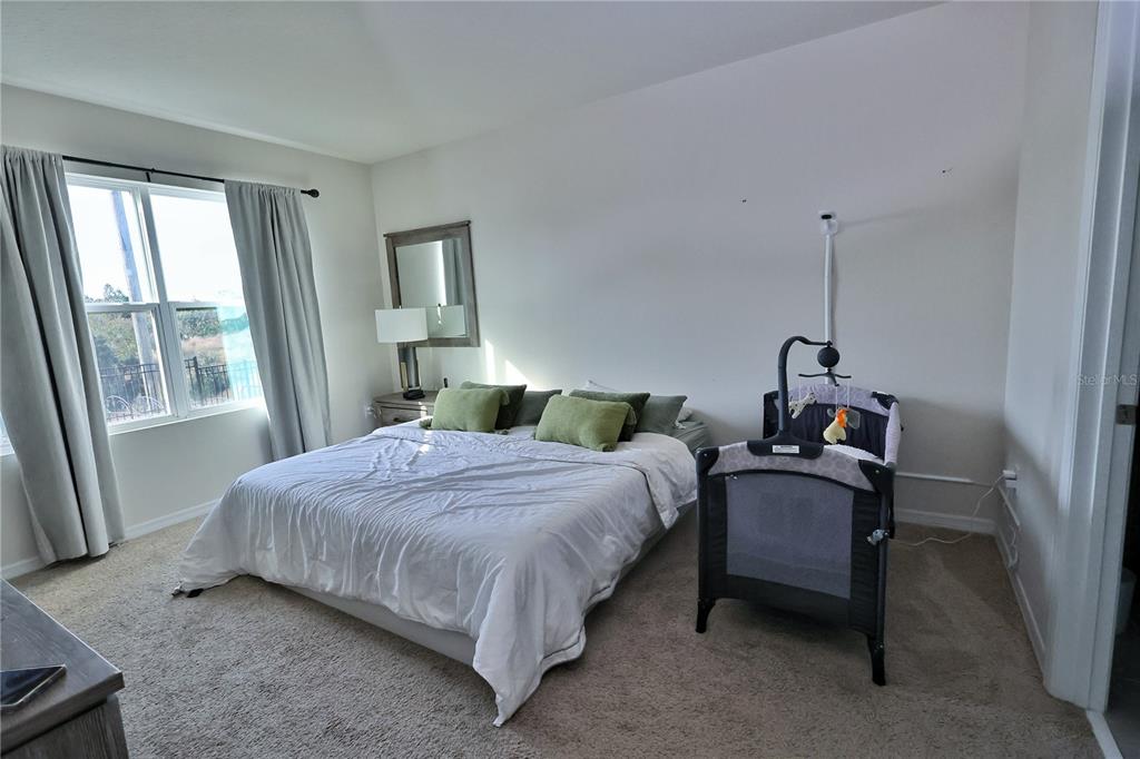 1724 Buckeye Road Davenport, FL 33837 - Photo 44 of 53 a bedroom with a bed chair and window