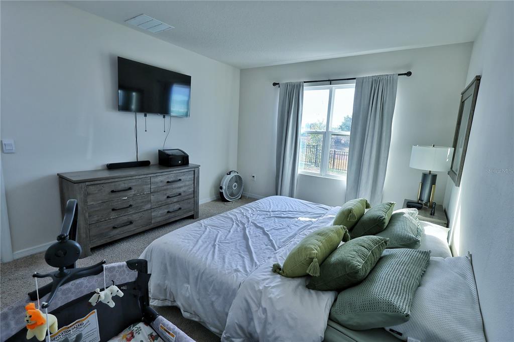 1724 Buckeye Road Davenport, FL 33837 - Photo 45 of 53 a bedroom with a bed and flat screen tv